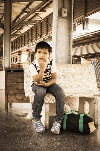 The asian little boyl sit alone at inner train, vintage tone — стоковое фото