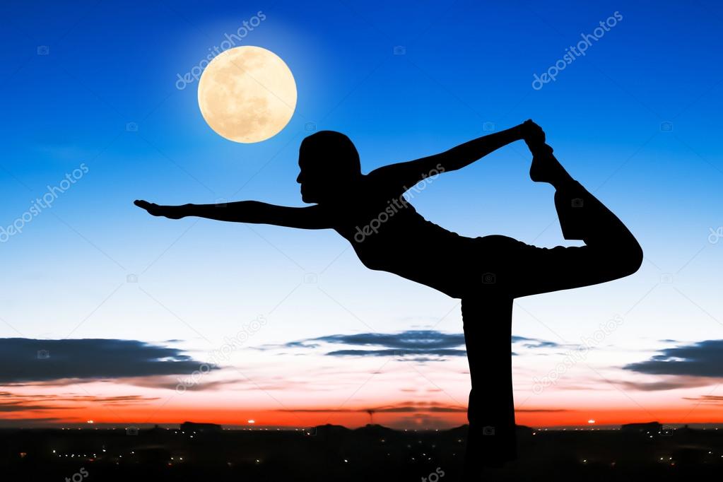 Silhouette young woman practicing yoga  on night full moon backg
