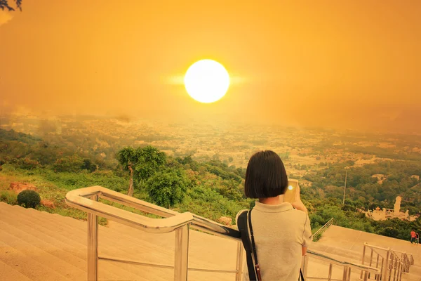 Азіатська дівчина робить фото захід сонця — стокове фото
