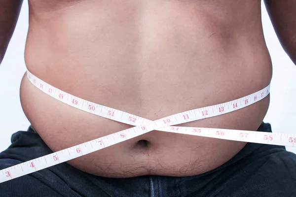 Fat Man is measuring his belly. — Stock Photo, Image