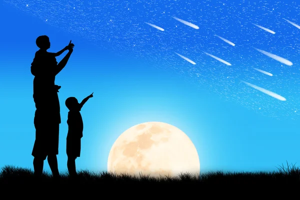 Silhouette of father and  little boy two Brothers look at meteor — Stock Photo, Image