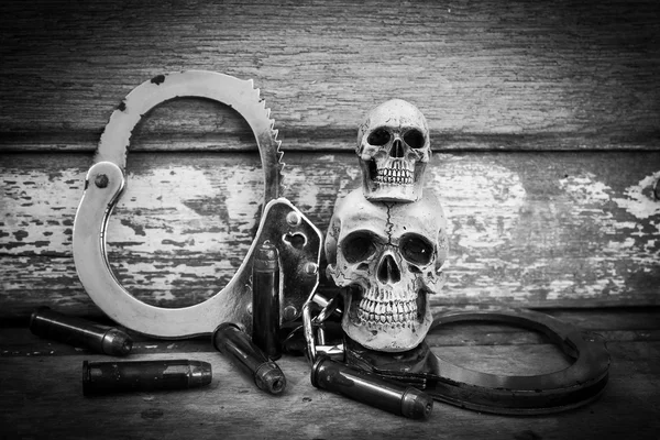 Still life and vintage of skull human with handcuff and bullet . — Stock Photo, Image