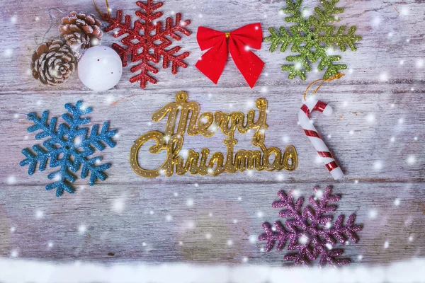 Merry Christmas on snow and wooden background — Stock Photo, Image