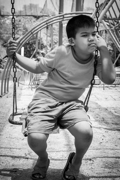 Asian boy sad alone at playground blank and white tone — Stock Photo, Image