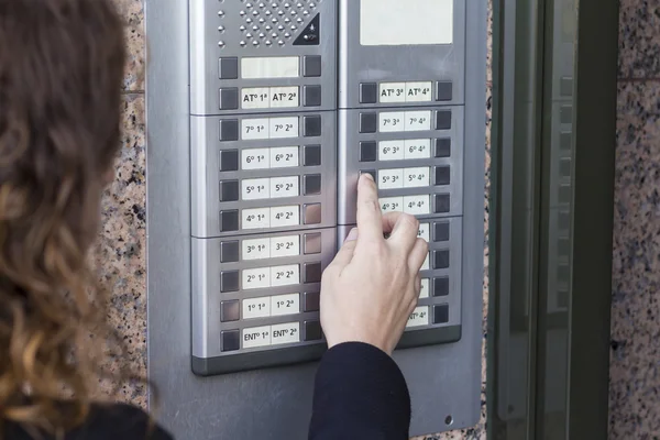 Woman  calling on the intercom — Stock Photo, Image