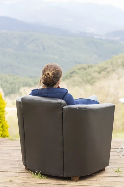 Woman sitting in a armchair — Stock Photo, Image