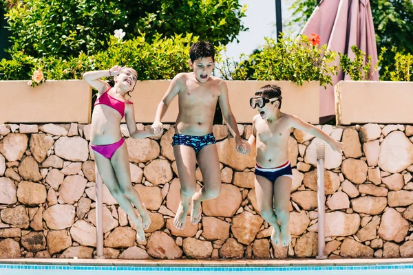 Three Kids Jumping Pool — Stock Photo, Image