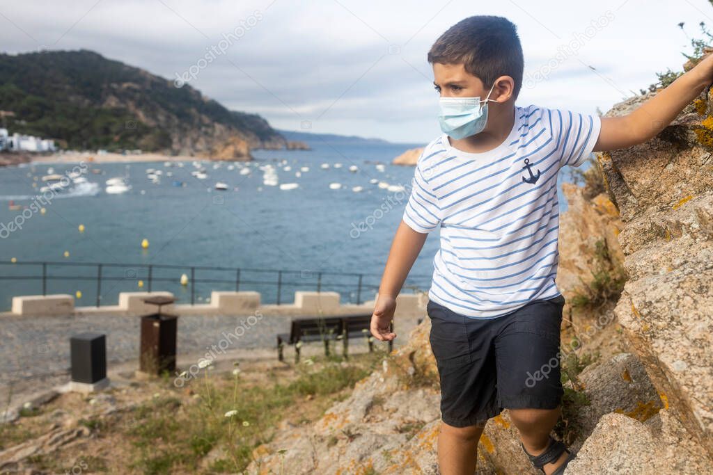 Child on vacation on the coast near the sea