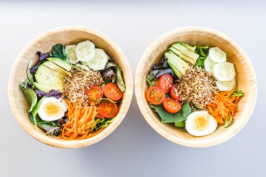 Havuç, yumurta, salatalık, avokado, domates ve kuzu marullu esmer pirinç salatası. Üst görünüm.