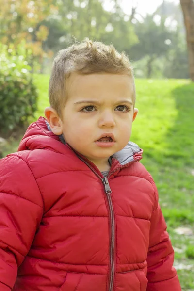 Angry kid with red coat — Stock Photo, Image