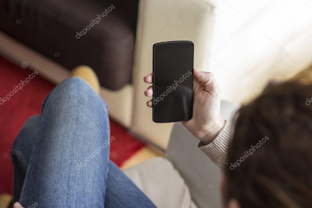 Woman use of the mobile phone at home
