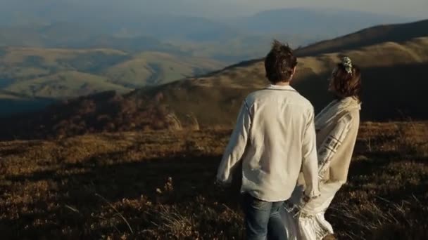 Couple in embroidery walking in picturesque meadow — Stock Video