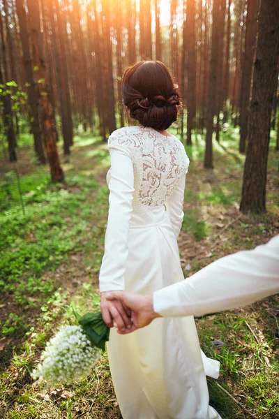 Wedding photosession of young couple near forest — Stock Photo, Image