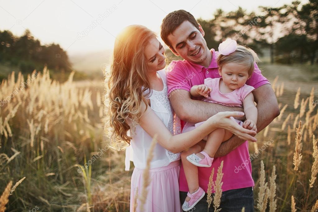 beautiful family of three people, mom dad and daughter