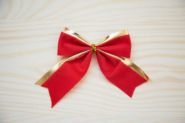 Red ribbon on a wood background with clipping paths. — Stock Photo, Image
