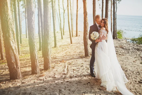 Couple marié courant sur une plage de sable — Photo