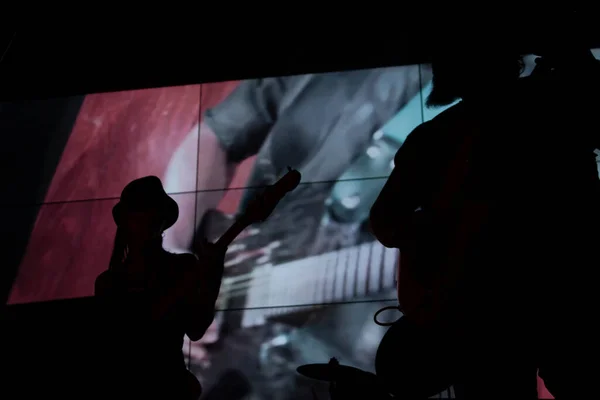 Silhouettes of people playing instruments setting the night life in Mexico City