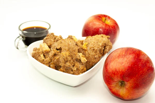 Inside a heart shaped bowl pair of apples oatmeal cookies with apple squares and coffee energizing in the day Mexico