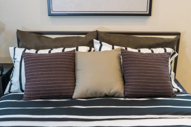 kahverengi, siyah ve beyaz yastıklar ile modern yatak odası