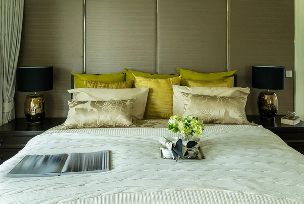 Decorative set with book,tea set and glasses on the bed