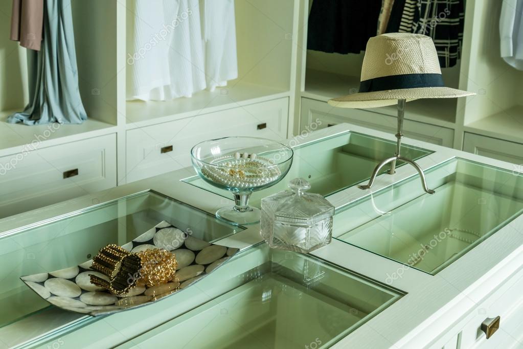 White Hat And Jewelry Set On A Dresser Table In A Contemporary R