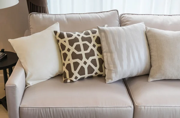 Modern living room with row of pillows on sofa — Stock Photo, Image