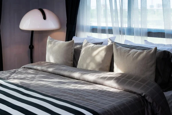 Modernes Schlafzimmer mit Kissen und weißer Lampe — Stockfoto