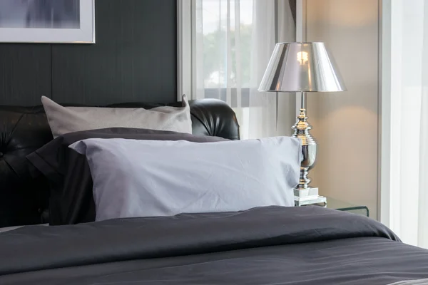 Moderno dormitorio de lujo con almohadas y lámpara — Foto de Stock