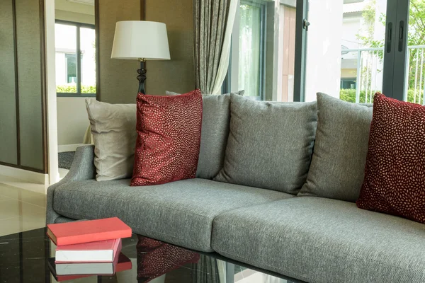 modern living room design with red pillows on sofa and lamp