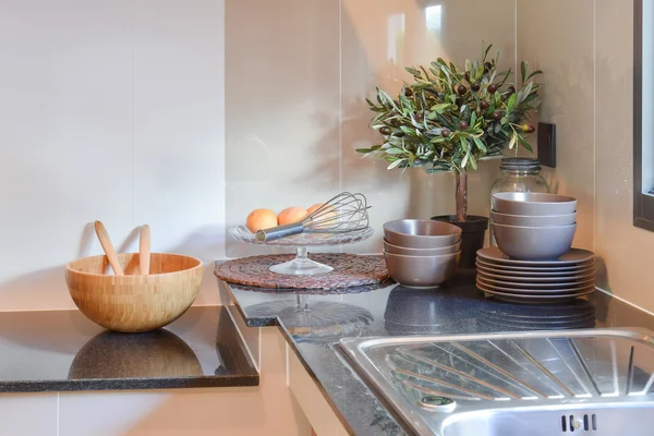 Ceramic kitchenware on the marble worktop and shelf — Stock Photo, Image