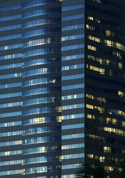 Windows of office buildings illuminated at night for background — Stock Photo, Image