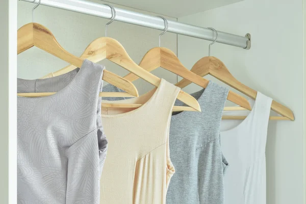 Female clothes on hangers in wardrobe — Zdjęcie stockowe