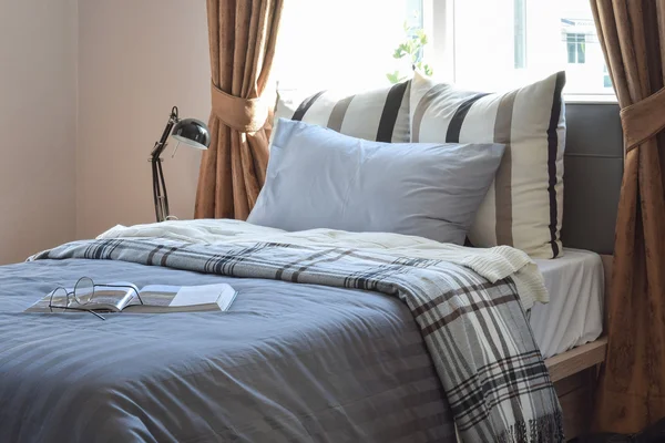 Modern bedroom with brown and grey striped pillows at home — Stock Photo, Image