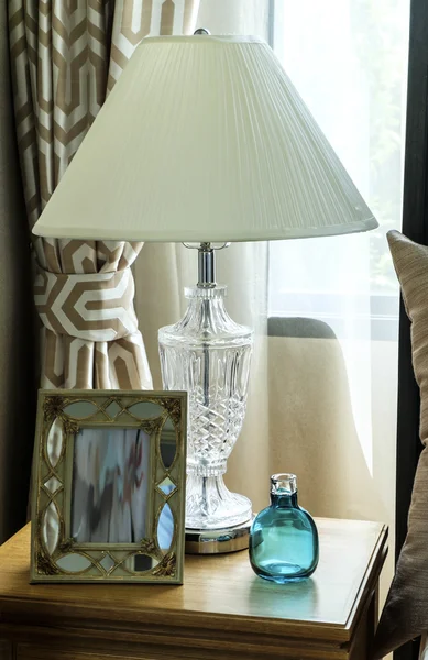 Bedside table with lamp, and picture frame