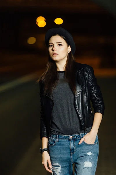 Woman at night road waving for car