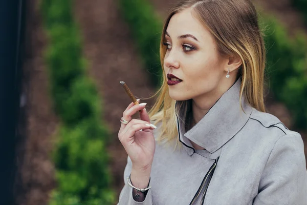 Giovane donna fumare sigaretta sulla panchina — Foto Stock