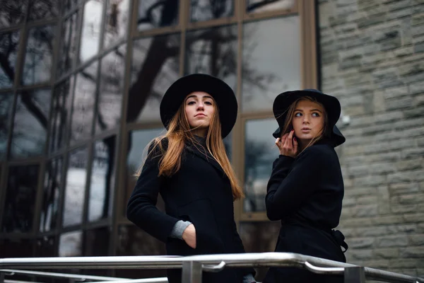 Две девушки идут по улице и позируют перед камерой — стоковое фото