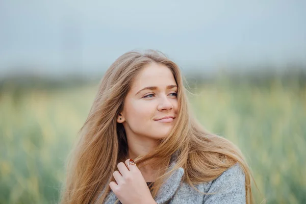 Rubia mujer de pelo sentado en el banco y sonrisa — Foto de Stock