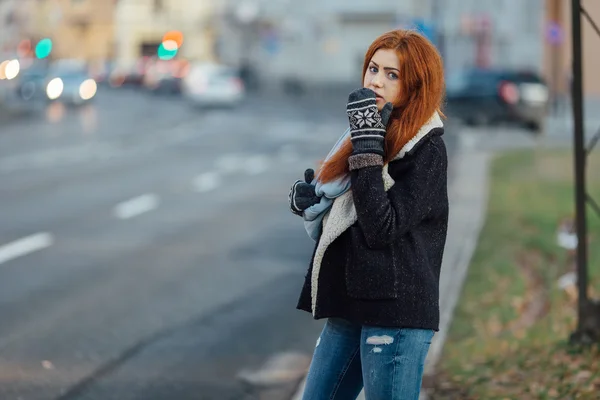 Red-haired girl standing on the street and laugh — Stok fotoğraf