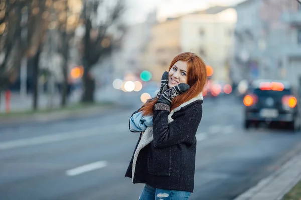Red-haired girl standing on the street and laugh — ストック写真