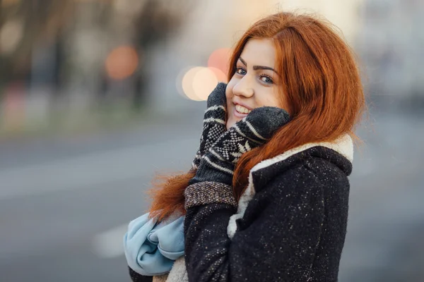 Red-haired girl standing on the street and laugh — ストック写真