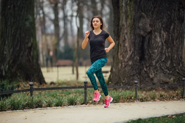 Jeune fille sportive qui court dans le parc — Photo