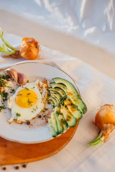 Frühstück mit Toast, Eiern, Avocado, Zwiebeln, Papier und Knoblauch — Stockfoto