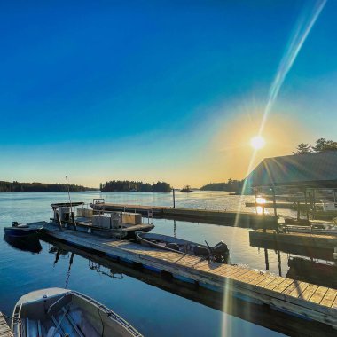 gananoque, canada - 22 October 2022 : saint lawrence river with boats docked and wooden pier in the thousand island regions
