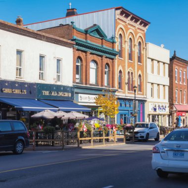 gananoque, canada - 22 October 2022 : restaurant and stores on colorful main street in small town