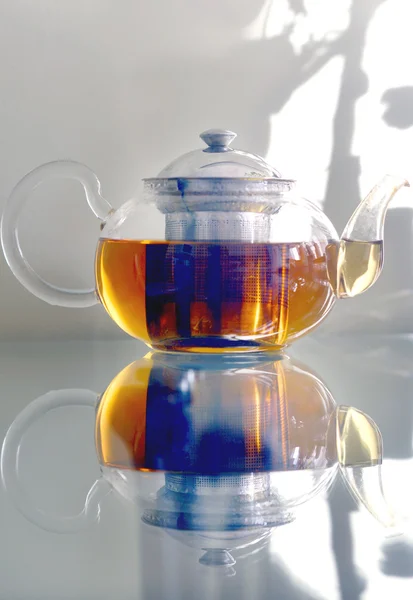 Glass teapot standing on a glass table. — Stock Photo, Image