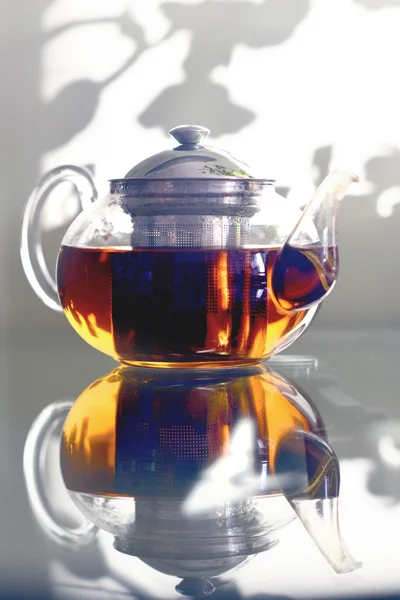 Glass teapot standing on a glass table. — Stock Photo, Image