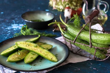  Baharat ve bitkilerle dolu bir tabakta taze salatalık, alternatif öğle yemeği, seçici odaklanma.