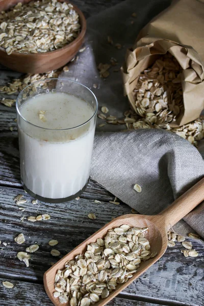 A oats drink, Vegatorian alternative to milk and oatmeal on a rustic table