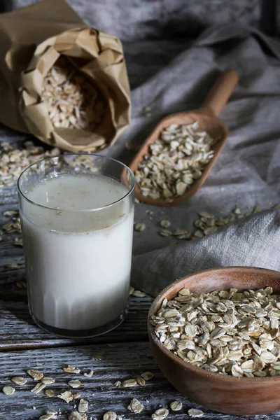 A oats drink, Vegatorian alternative to milk and oatmeal on a rustic table